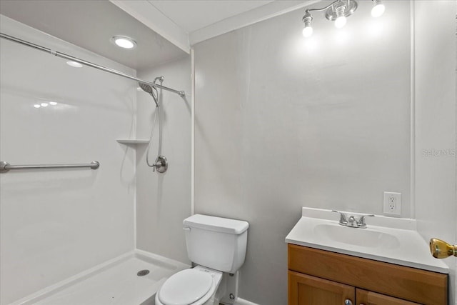 bathroom with vanity, toilet, and a shower