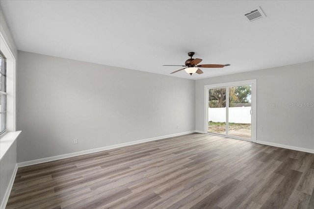 empty room featuring ceiling fan and dark wood-type flooring