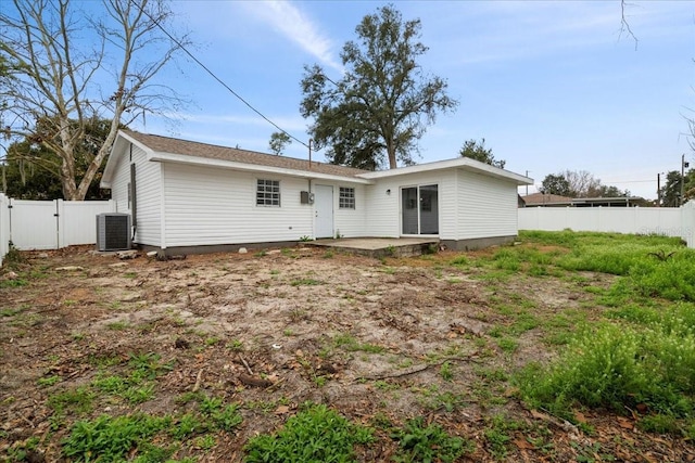 rear view of property with central AC and a patio