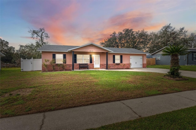 view of front of home featuring covered porch, a garage, and a lawn