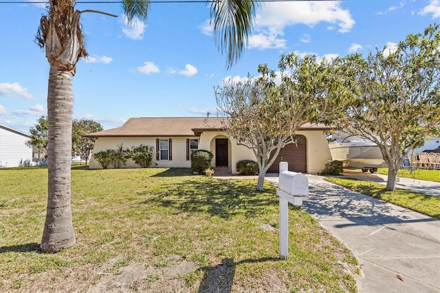 single story home with a front lawn and a garage