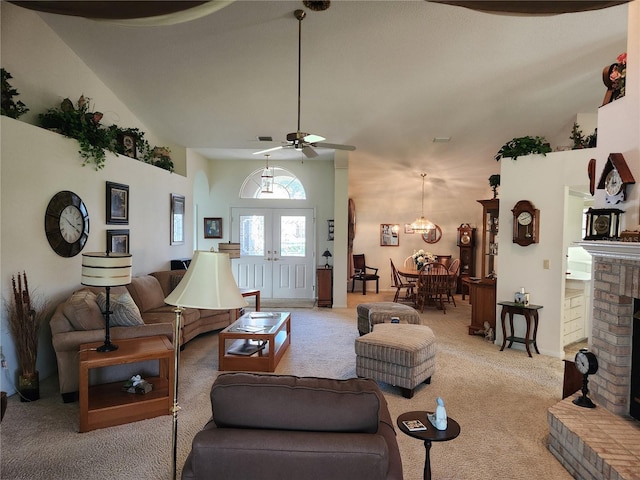 carpeted living area featuring french doors, a fireplace, a high ceiling, and ceiling fan