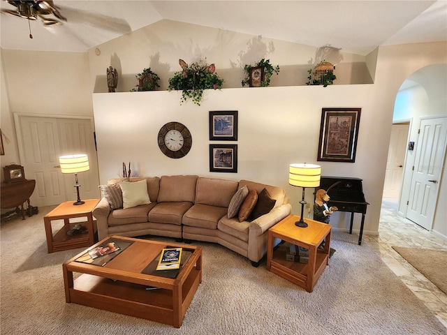 living area with arched walkways, high vaulted ceiling, and ceiling fan