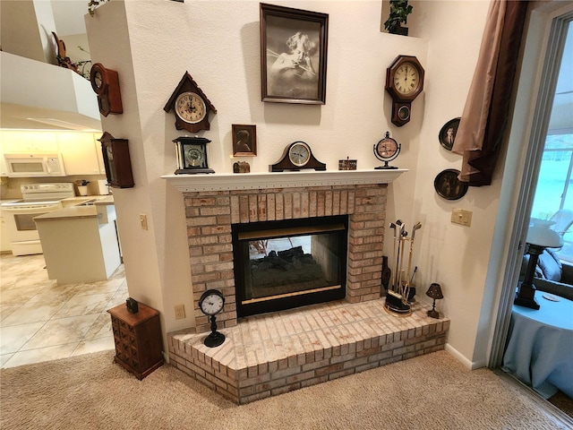 interior details with white appliances, a brick fireplace, carpet flooring, and baseboards