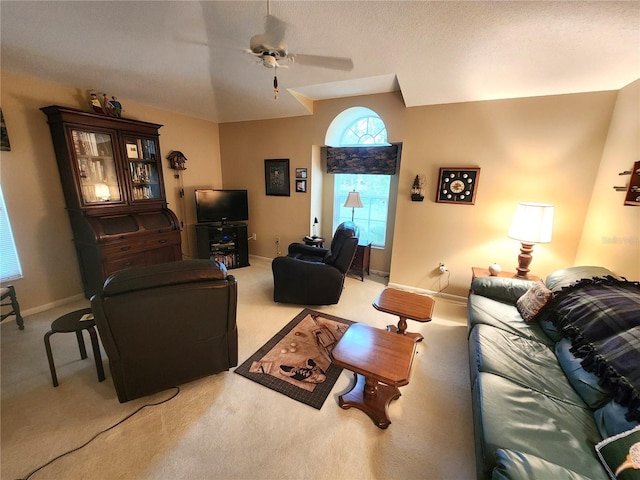 living area featuring carpet floors, ceiling fan, and baseboards