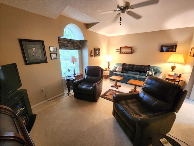 living area featuring a textured ceiling, light colored carpet, a ceiling fan, baseboards, and vaulted ceiling