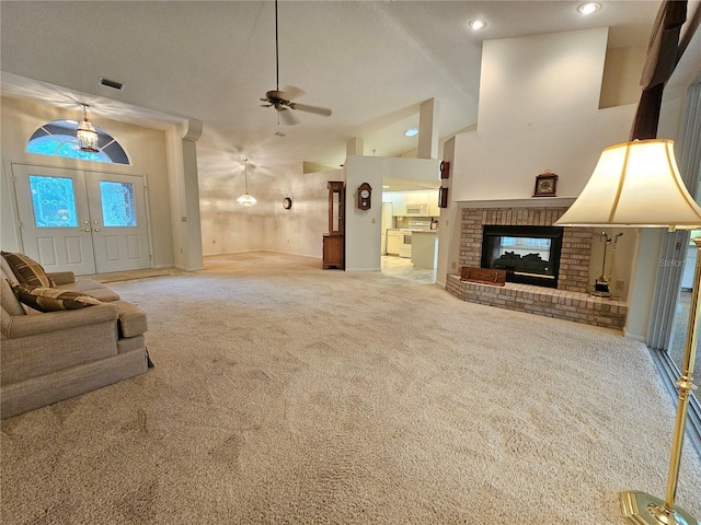 8157 Hidden Hills Dr, Spring Hill, FL 34606 - unfurnished living room featuring carpet floors, ceiling fan, a fireplace, recessed lighting, and vaulted ceiling
