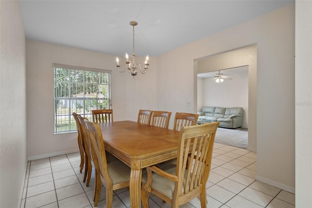 dining room featuring light tile patterned floors, baseboards, and a notable chandelier