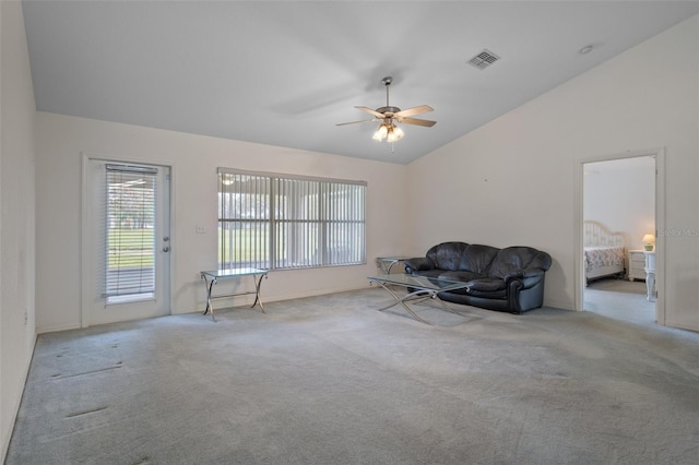 unfurnished room featuring lofted ceiling, a ceiling fan, visible vents, and carpet flooring