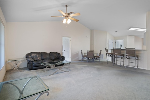 carpeted living area featuring visible vents, vaulted ceiling, baseboards, and ceiling fan