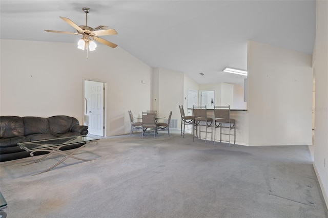 living room featuring lofted ceiling, ceiling fan, and carpet