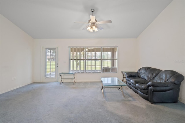 carpeted living area with vaulted ceiling, a ceiling fan, and baseboards