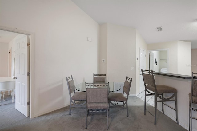 dining area with carpet, visible vents, and baseboards