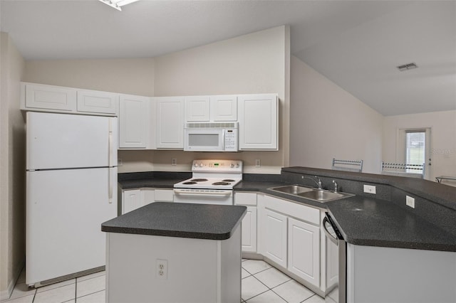 kitchen featuring visible vents, white cabinetry, a sink, white appliances, and a peninsula