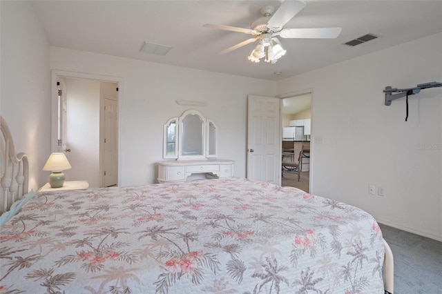 carpeted bedroom with a ceiling fan and visible vents