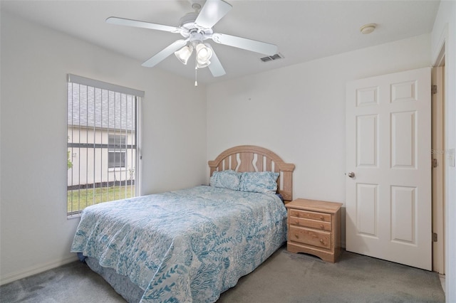 carpeted bedroom featuring visible vents and ceiling fan