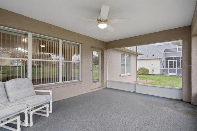 unfurnished sunroom with a wealth of natural light and ceiling fan