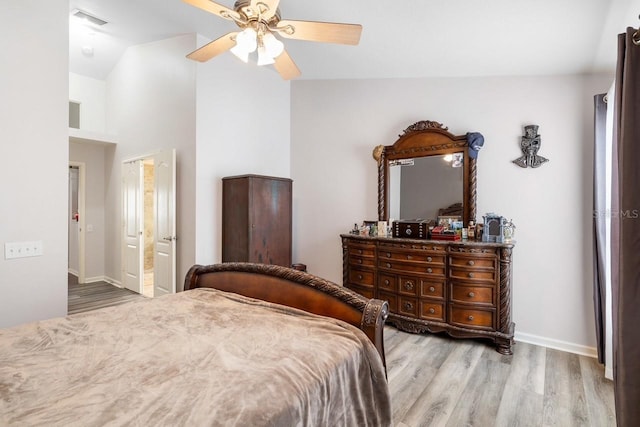 bedroom featuring lofted ceiling, visible vents, a ceiling fan, light wood-type flooring, and baseboards