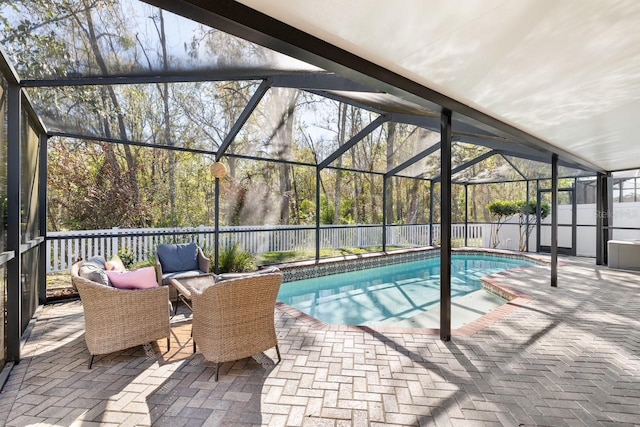 view of swimming pool with a lanai, a patio area, a fenced backyard, and a fenced in pool