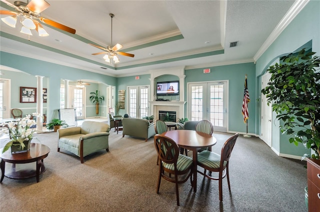 5903 War Admiral Dr, Wesley Chapel, FL 33544 - dining area with a raised ceiling, carpet floors, ornamental molding, ceiling fan, and a glass covered fireplace