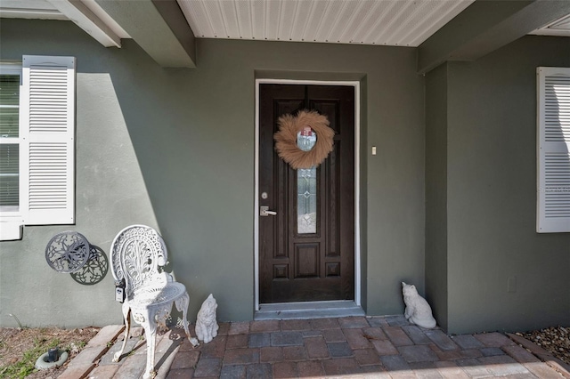 property entrance featuring stucco siding