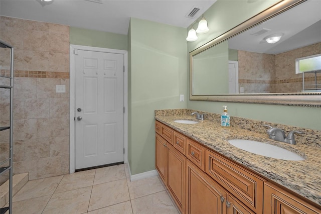 full bathroom with tile patterned flooring, visible vents, a sink, and tiled shower