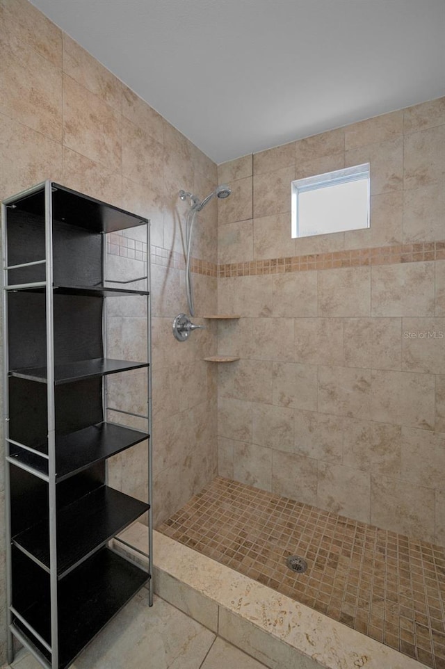 bathroom with a tile shower