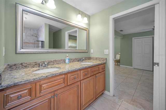 full bathroom featuring ceiling fan, double vanity, a sink, and visible vents