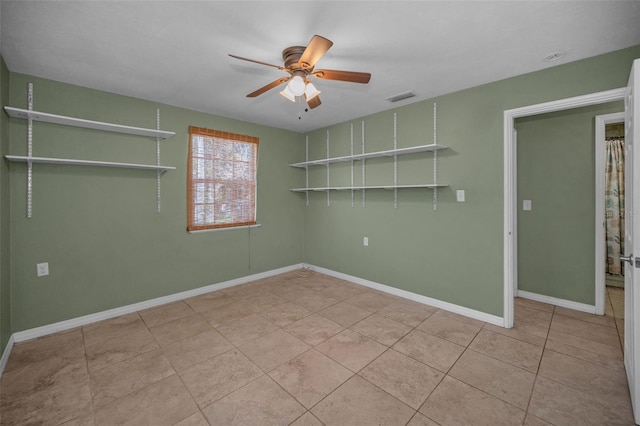 unfurnished room featuring ceiling fan, visible vents, baseboards, and light tile patterned flooring