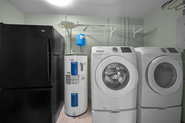 laundry area with laundry area, electric panel, tile patterned floors, washing machine and clothes dryer, and water heater