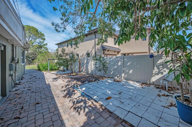 view of patio featuring fence