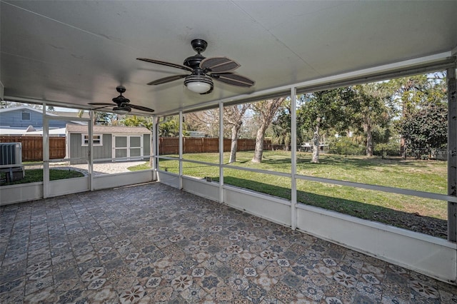 unfurnished sunroom with a ceiling fan