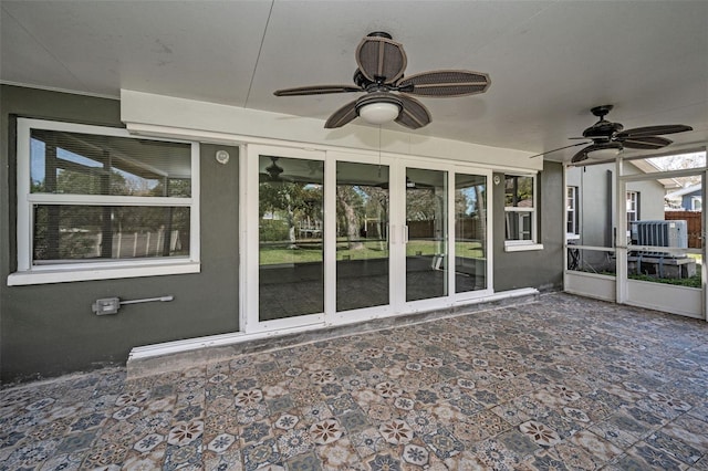 unfurnished sunroom with a ceiling fan