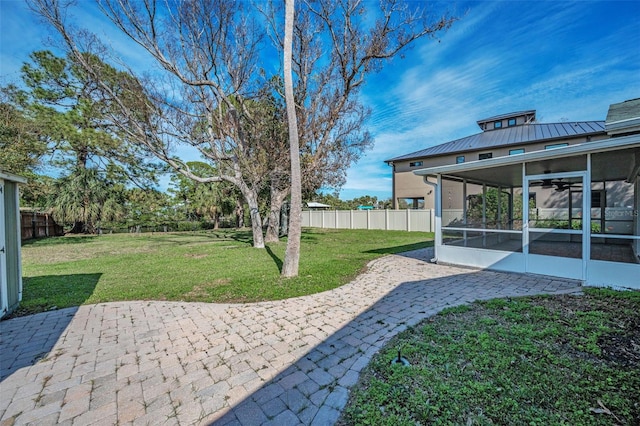 view of yard with a sunroom, a patio area, and fence