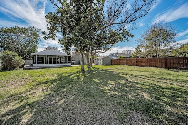 view of yard featuring a sunroom and fence