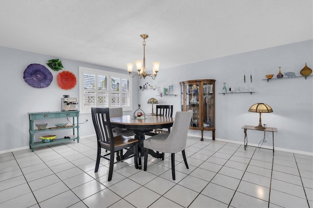 dining room with baseboards, a notable chandelier, and light tile patterned flooring