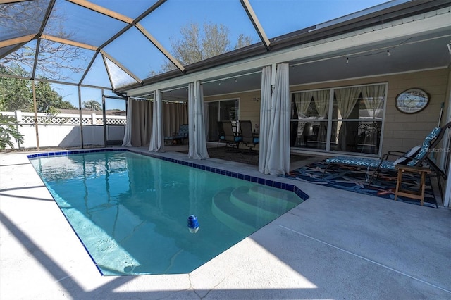 view of pool featuring a fenced in pool, glass enclosure, a patio, and fence