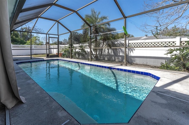 view of swimming pool featuring a lanai, a patio area, a fenced backyard, and a fenced in pool