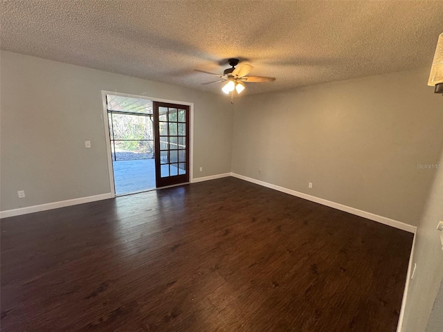 spare room featuring a textured ceiling, dark hardwood / wood-style floors, and ceiling fan