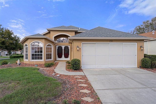 view of front facade with a front lawn and a garage