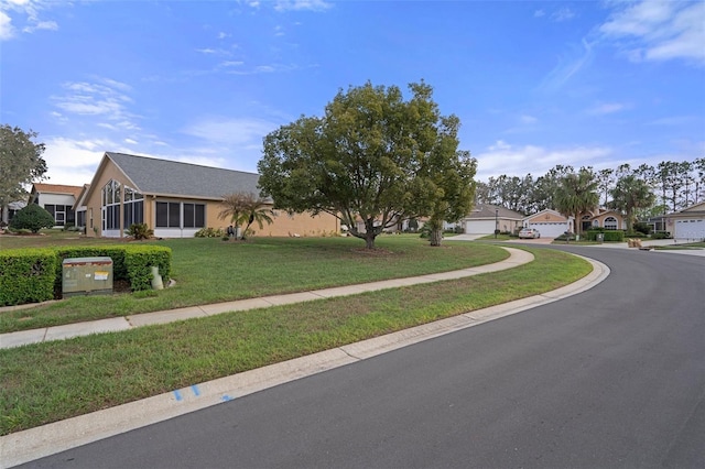 ranch-style house featuring a front lawn and a garage