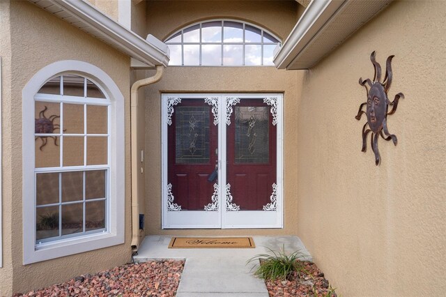 entrance to property with stucco siding
