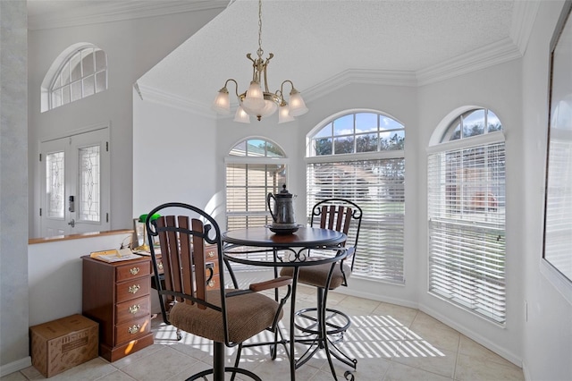 dining room featuring light tile patterned floors, ornamental molding, and an inviting chandelier