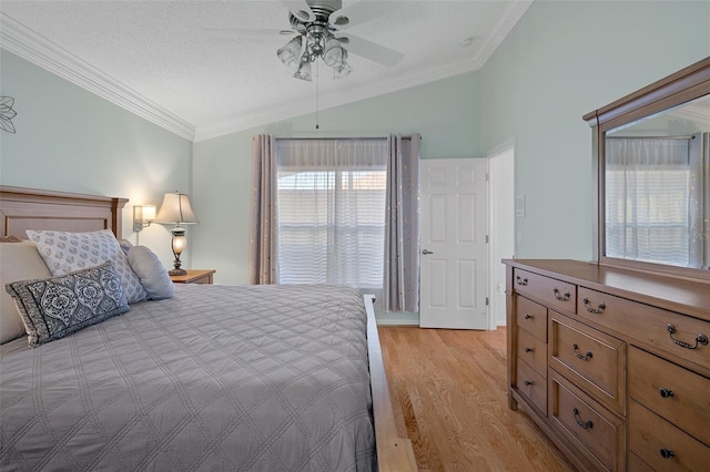 bedroom with a textured ceiling, light wood-type flooring, vaulted ceiling, and crown molding