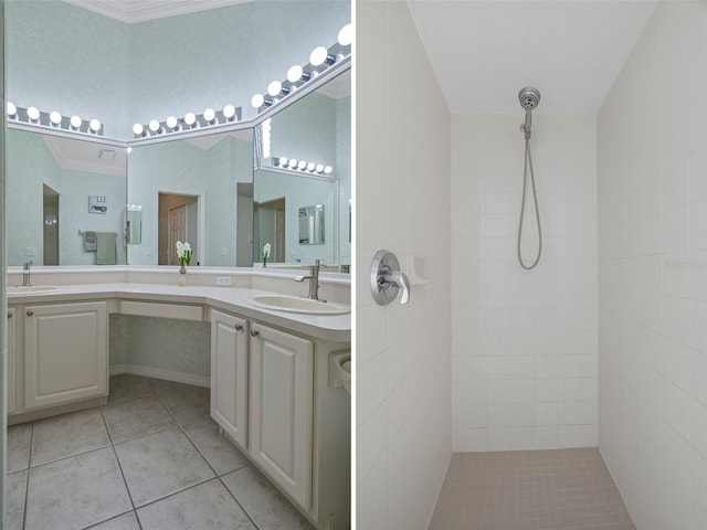 full bath featuring double vanity, tiled shower, a sink, and tile patterned floors