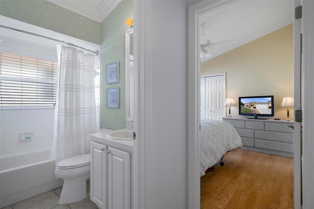 bathroom featuring ornamental molding, toilet, wood finished floors, a ceiling fan, and vanity