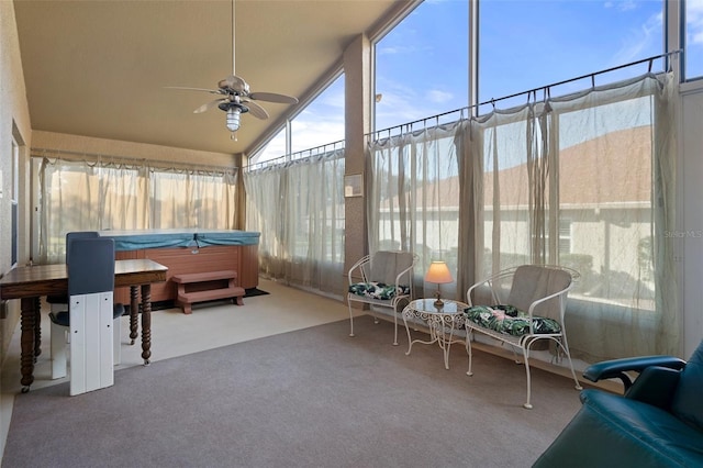 sunroom with a hot tub and ceiling fan