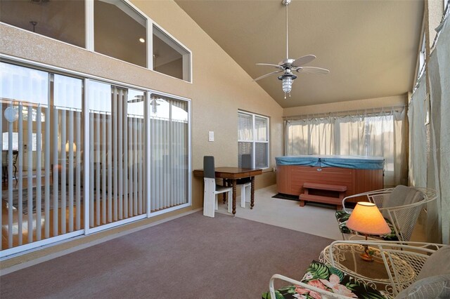 sunroom featuring a jacuzzi and a ceiling fan
