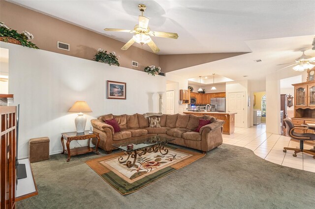 living room featuring a ceiling fan, light colored carpet, visible vents, and vaulted ceiling