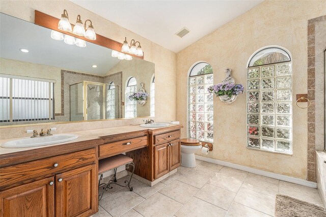 bathroom with visible vents, a sink, a shower stall, and double vanity